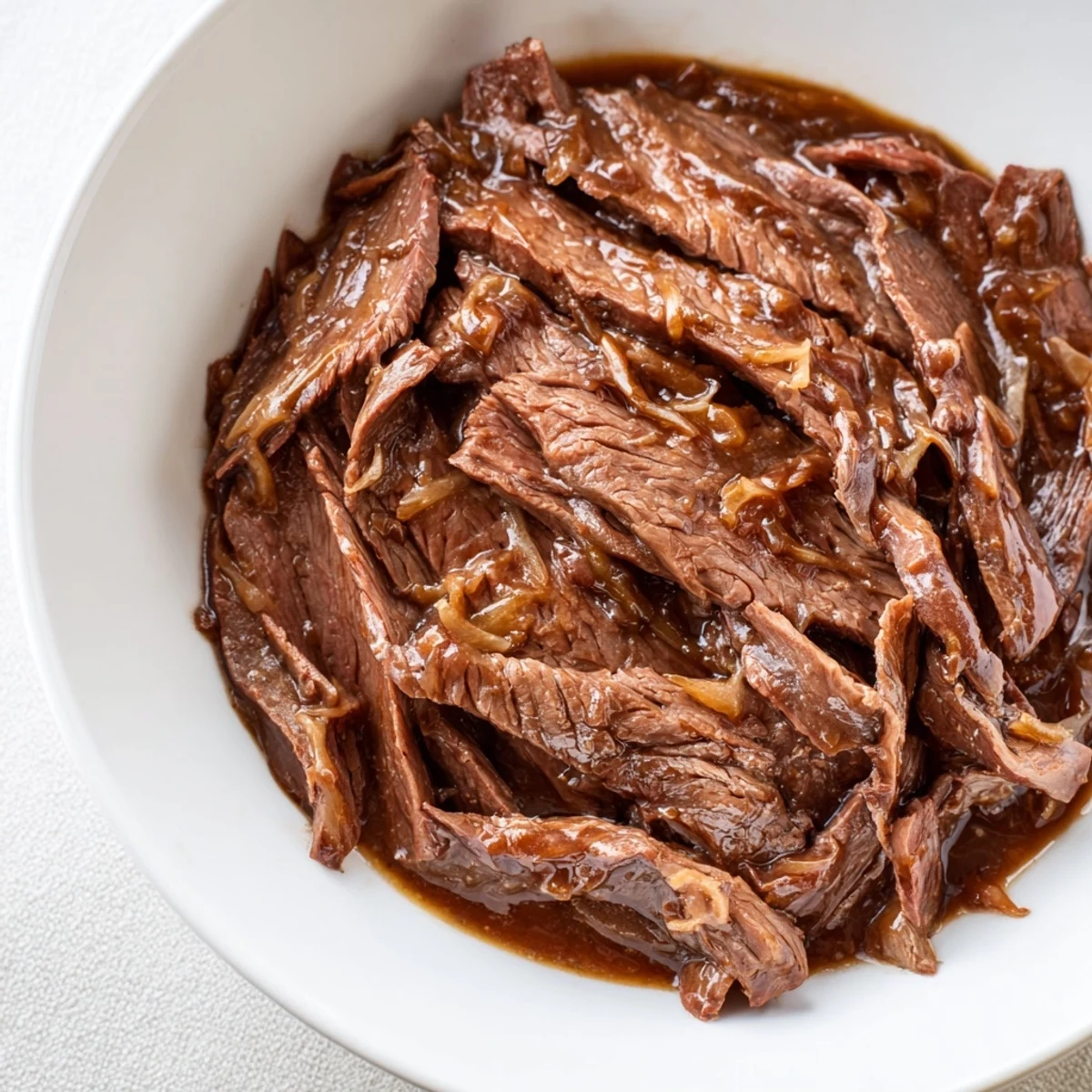 Rich brown sauce clings to every slice in this Ultimate Slow Cooker Mongolian Beef, ideal for a weeknight dinner.