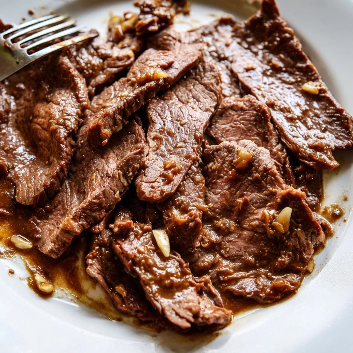 An overhead view of Ultimate Slow Cooker Mongolian Beef with green onions and sesame seeds, ready for a family dinner.