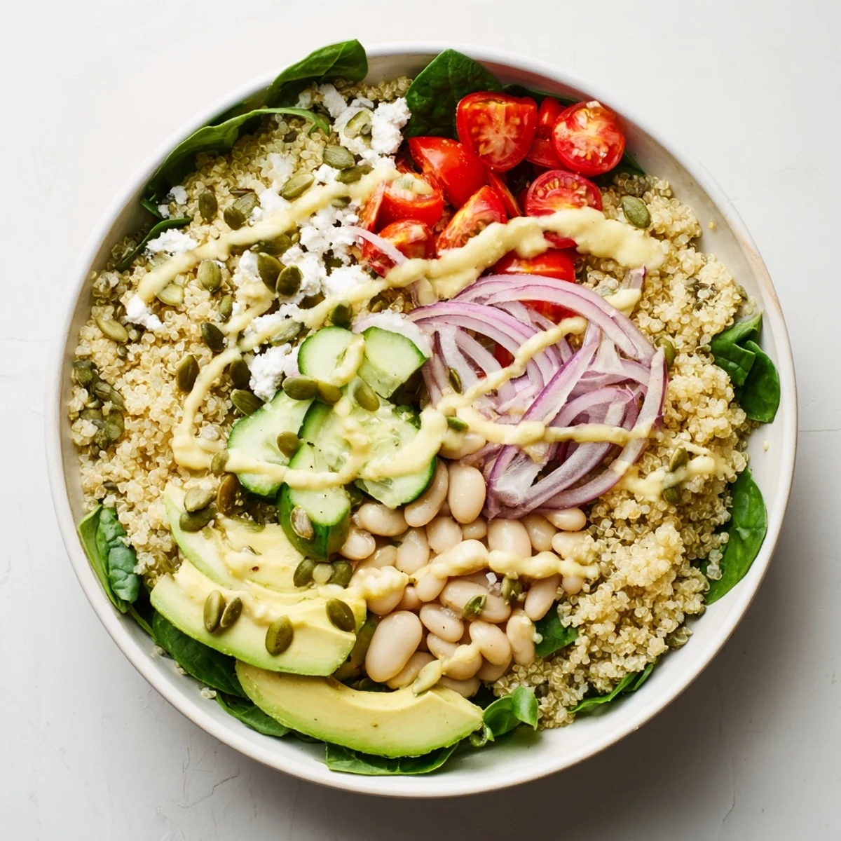Close-up of Spinach & White Bean Ultimate Protein Power Bowl with quinoa, spinach, and cherry tomatoes.