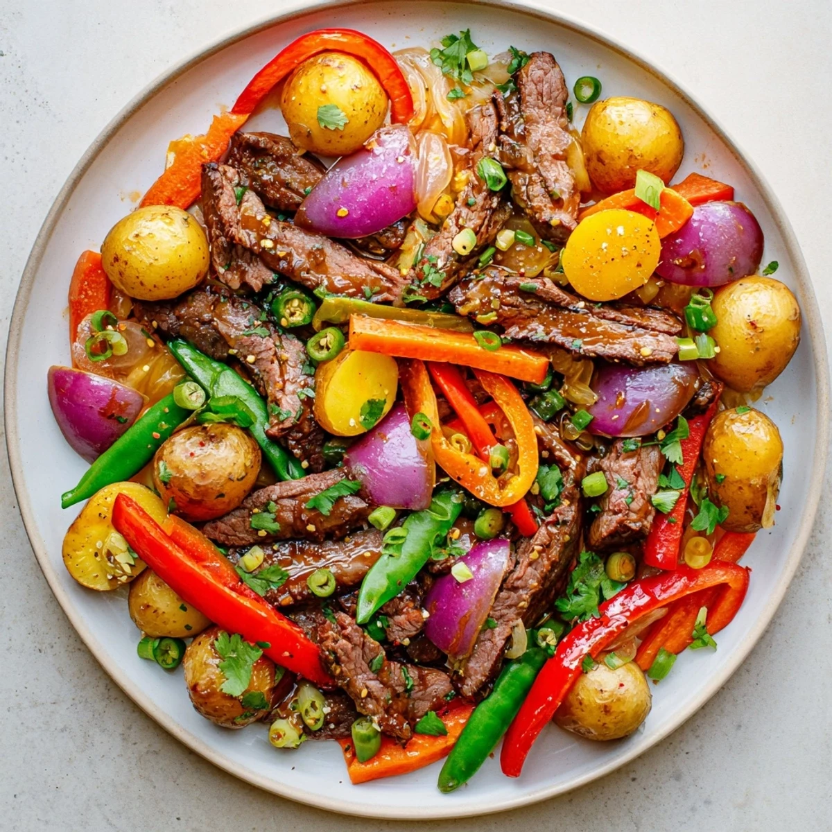 Blackstone Cowboy Stir Fry Dinner served hot with cilantro garnish and scallions on a platter.