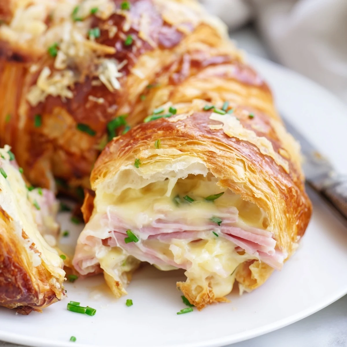Freshly baked Stuffed Croissants served on a wooden board with a green side salad for brunch.