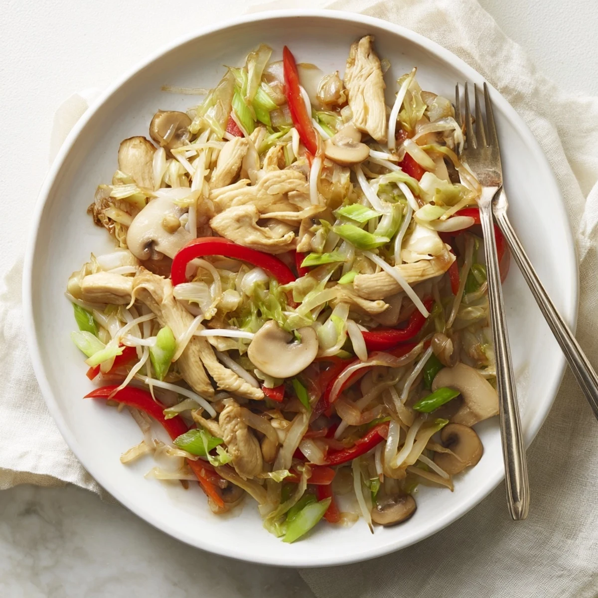 Colorful vegetable stir-fry with tender chicken pieces in a savory glossy Chop Suey sauce