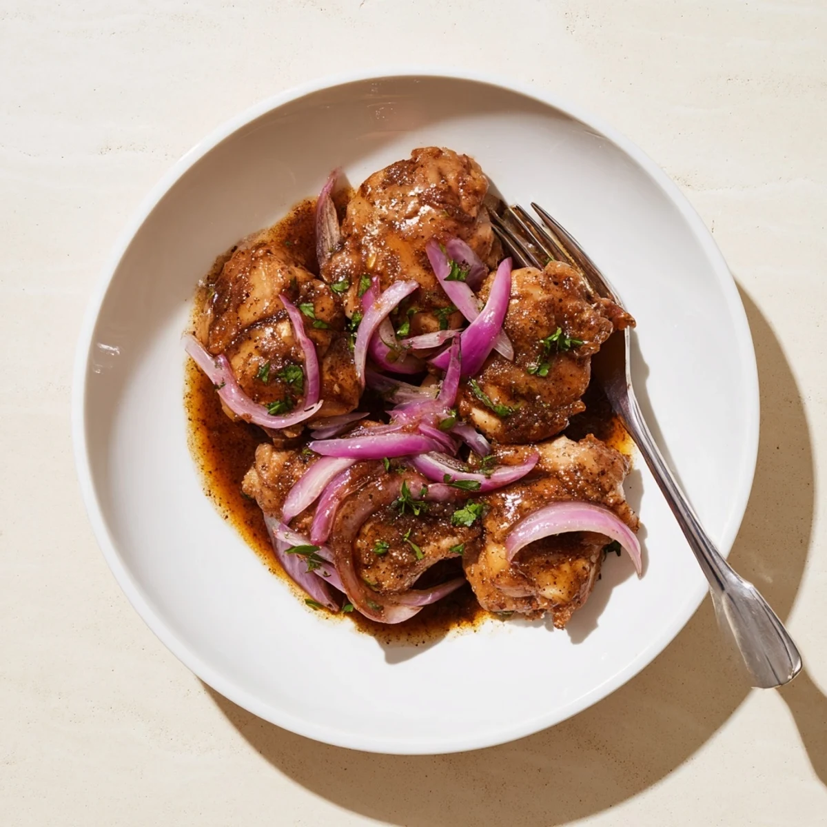 Golden slow cooker balsamic chicken thighs glazed in rich dark sauce garnished with fresh parsley