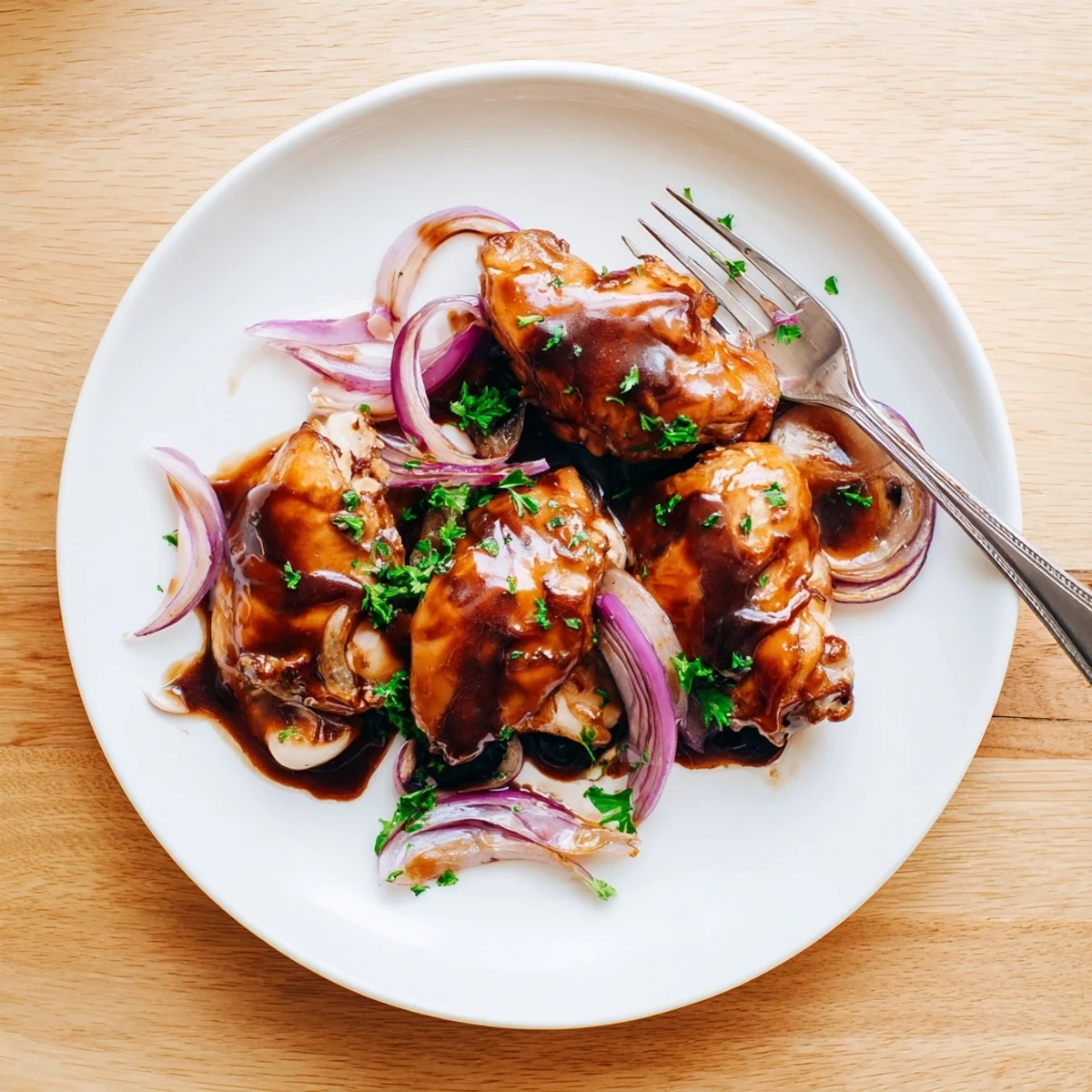 Plate of slow cooker balsamic chicken served over fluffy rice with thick glossy coating