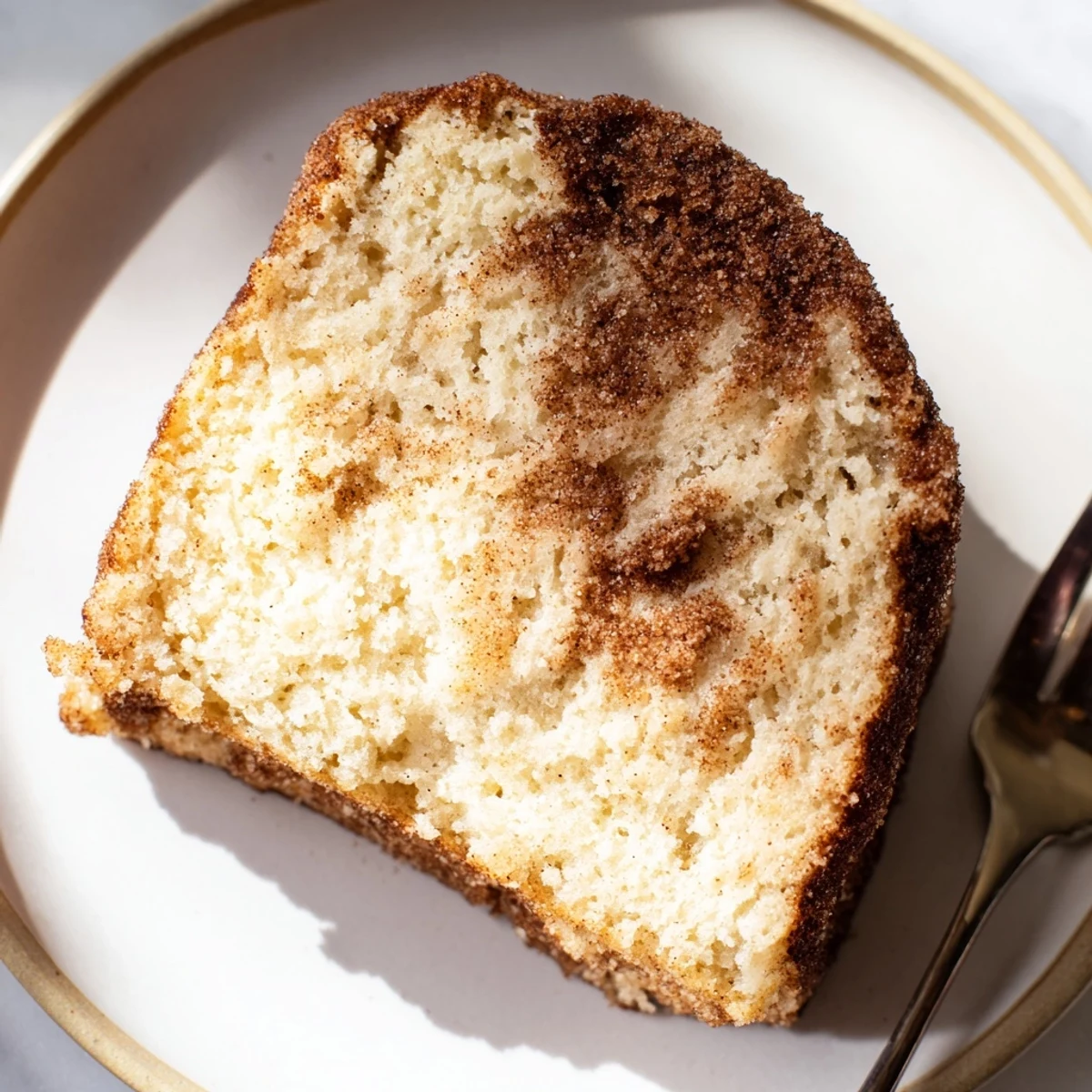 Golden cinnamon sugar donut bread fresh from the oven with a craggy sugary crust