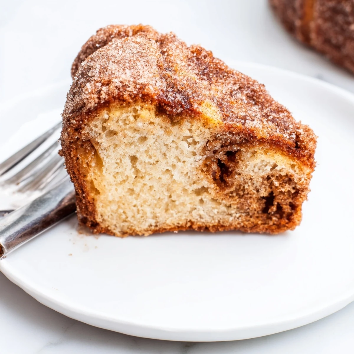 Loaf of homemade cinnamon sugar donut bread sprinkled with sparkling sugar topping