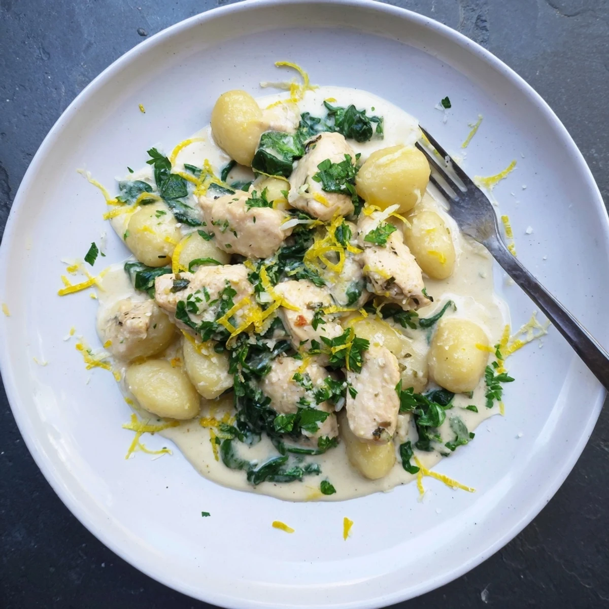 Golden chicken pieces and tender gnocchi swimming in bright lemon garlic sauce