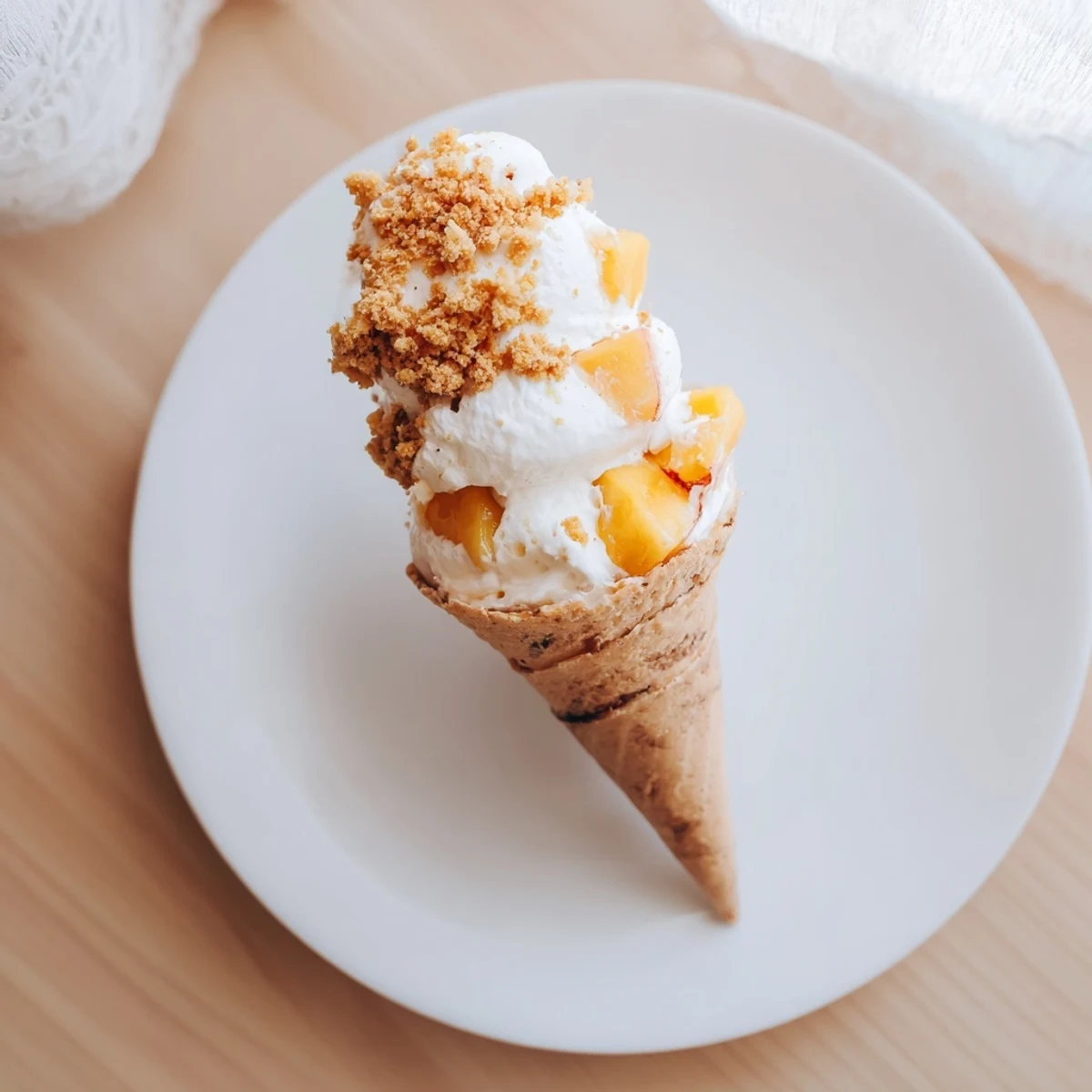 Golden waffle cones filled with fluffy cheesecake mousse topped with cinnamon spiced peaches
