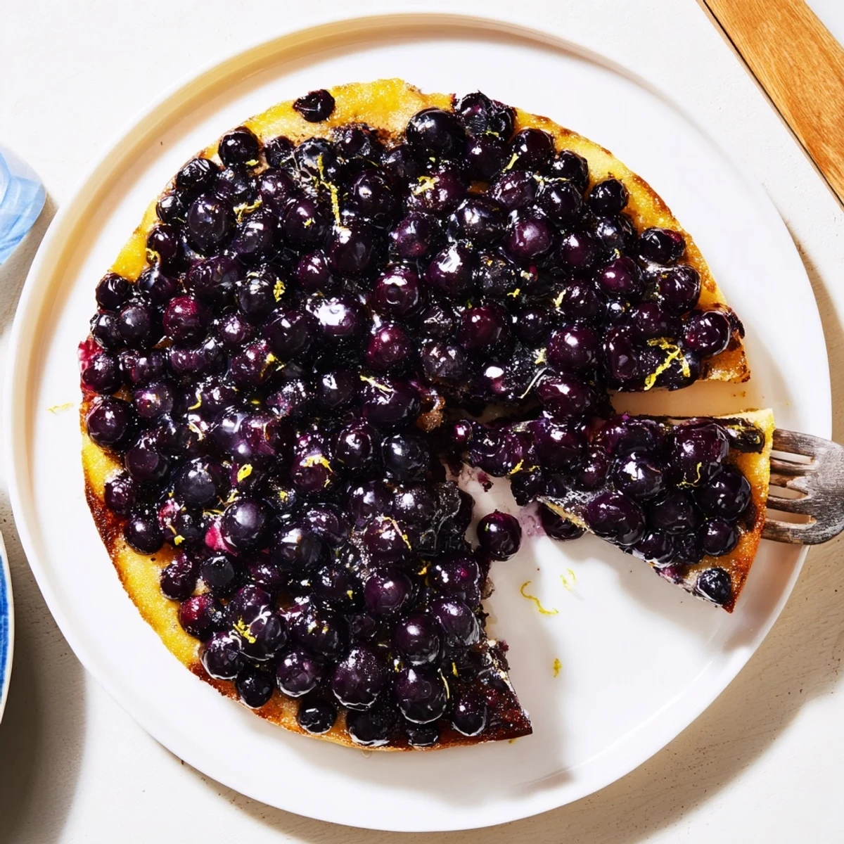 Moist buttery blueberry upside down cake inverted to reveal bubbling dark berry caramel layer