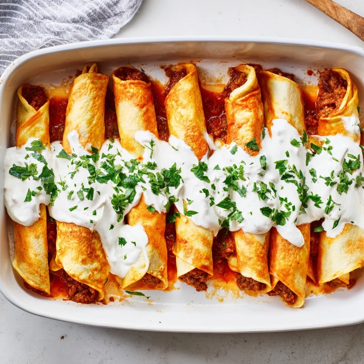 Traditional Hungarian stuffed crepes smothered in rich cream sauce with fresh parsley garnish
