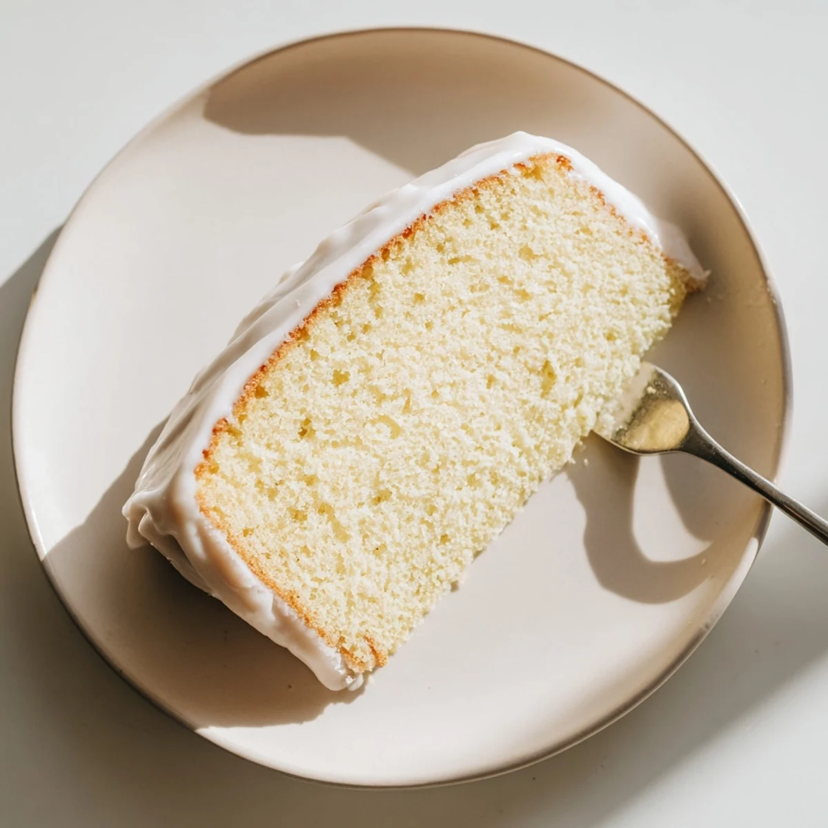 Classic church cake sliced and arranged on a platter with sweet creamy glaze dripping