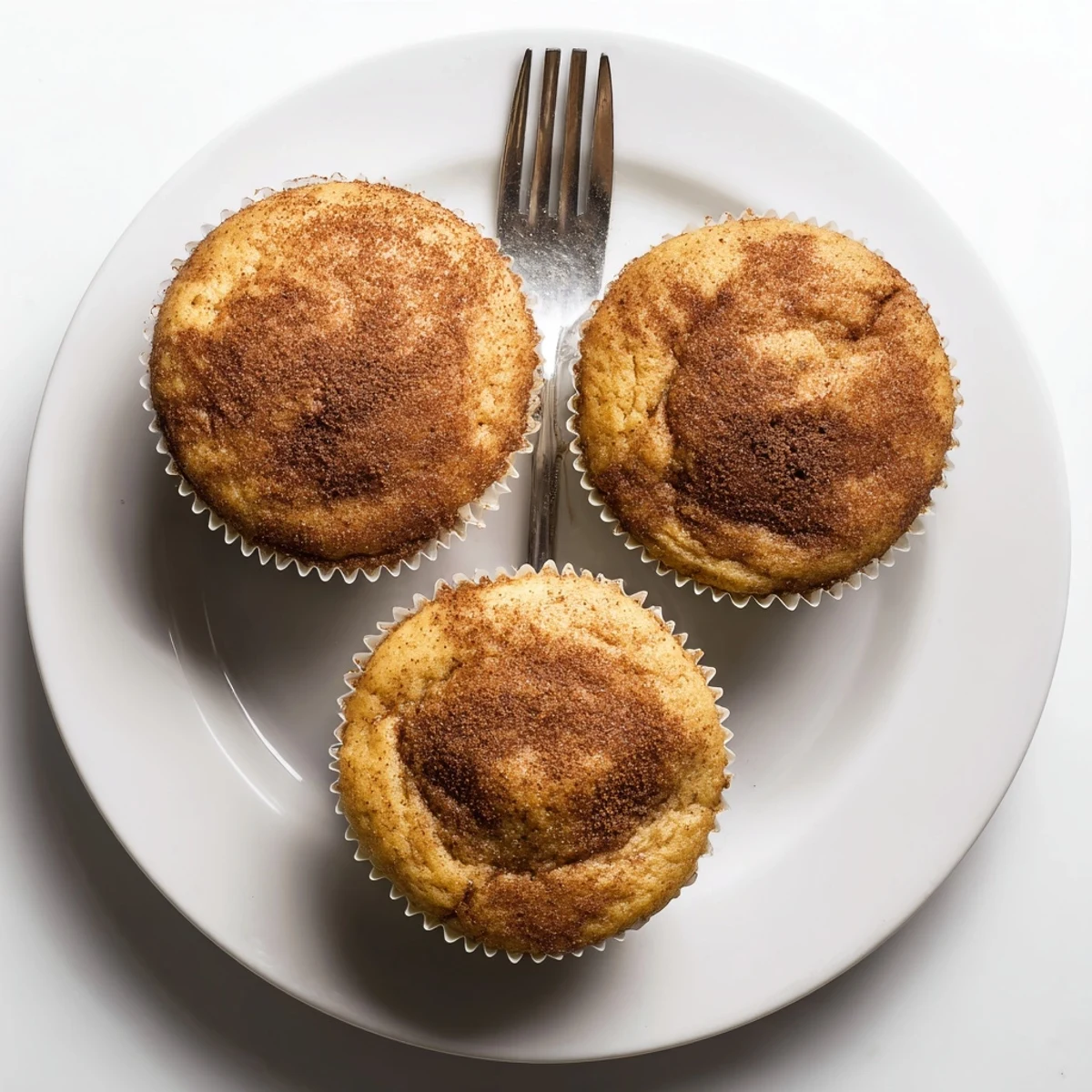 Soft banana muffins with golden tops on a wire cooling rack