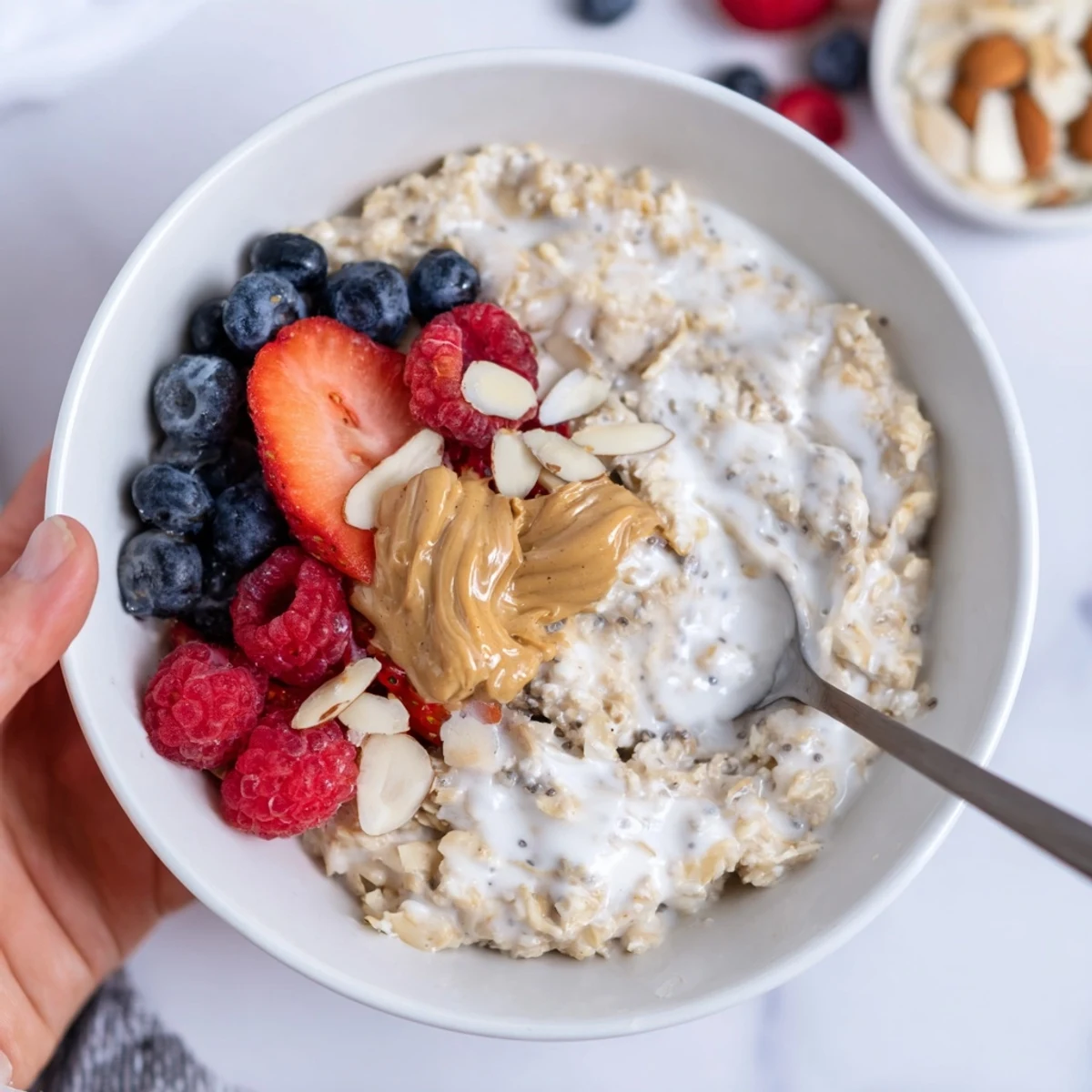 Protein Overnight Oats topped with fresh berries and crunchy nuts, chilled.