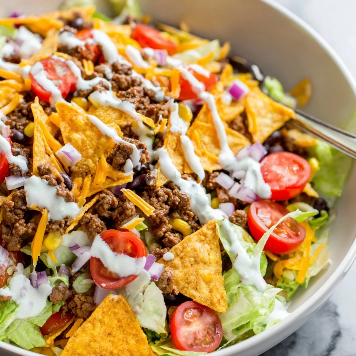 Bright Simple Doritos Taco Salad tossed in ranch, crisp romaine, zesty taco beef