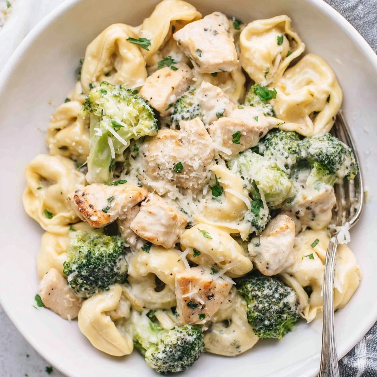 Spoonful of Creamy Garlic Parmesan Tortellini Chicken Broccoli Recipe with tender pasta, crisp broccoli