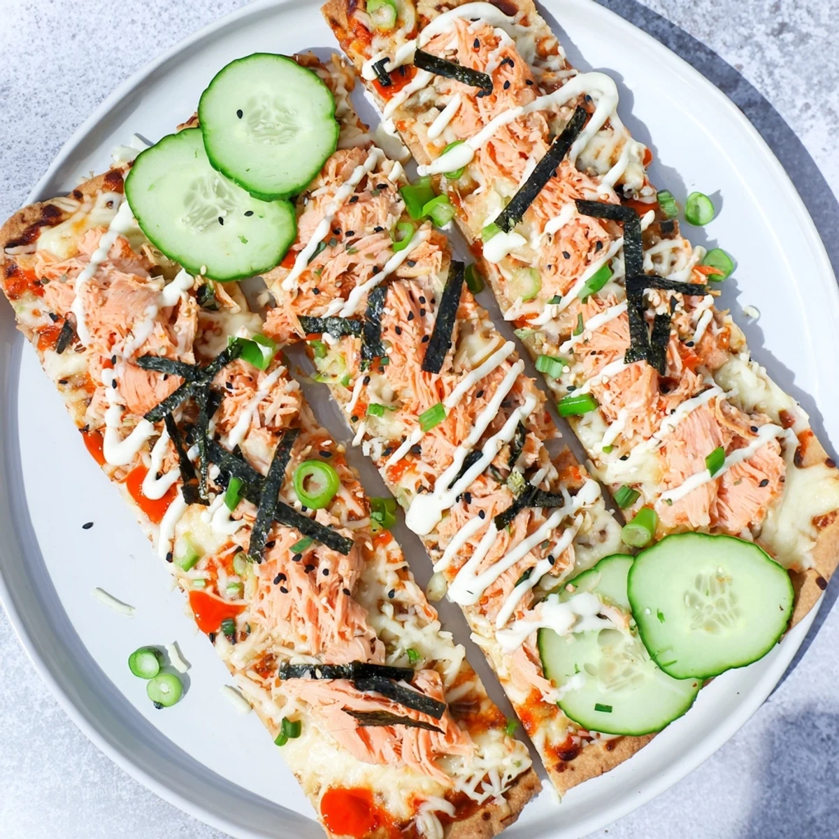 Crispy flatbread loaded with creamy salmon sushi rice mixture and melted mozzarella cheese