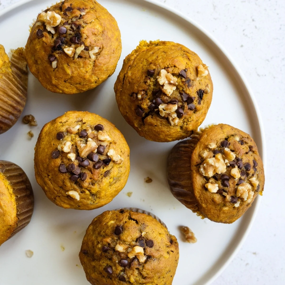 Spiced pumpkin banana muffins served warm with a drizzle of honey on plate