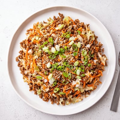 This skillet Egg Roll In A Bowl features ground pork and crisp coleslaw mix tossed in a sesame-ginger sauce.