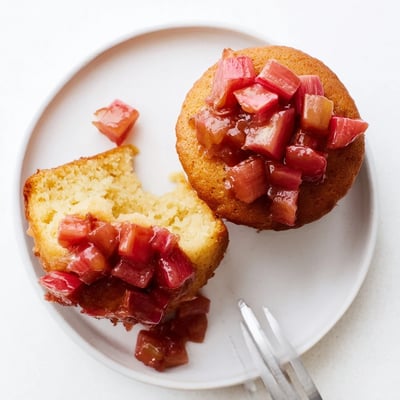 Tender upside down rhubarb muffins flipped to reveal glistening sweet-tart fruit topping